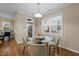 Bright dining area with a glass-top table, seating for four, and natural light from the exterior door and window at 5618 Wade Park Blvd, Raleigh, NC 27607