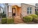 Inviting brick entrance with well-maintained landscaping and a stylish black front door at 5618 Wade Park Blvd, Raleigh, NC 27607