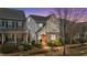Charming two-story home featuring manicured landscaping and a welcoming brick entryway at dusk at 5618 Wade Park Blvd, Raleigh, NC 27607