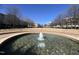 A decorative fountain surrounded by landscaping and commercial buildings in the distance at 5618 Wade Park Blvd, Raleigh, NC 27607