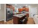 Kitchen with stainless steel refrigerator, center island with bar stools and seating, and granite countertops at 5618 Wade Park Blvd, Raleigh, NC 27607