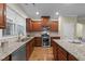 Well-equipped kitchen with stainless steel appliances, granite counters, and ample cabinet space at 5618 Wade Park Blvd, Raleigh, NC 27607