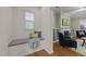 Cozy nook with a window seat and decorative pillows, leading to the living area with a fireplace and built-in shelves at 5618 Wade Park Blvd, Raleigh, NC 27607