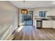 Bright kitchen features white cabinetry, laminate flooring, and sliding glass doors at 5850 Shady Grove Cir, Raleigh, NC 27609