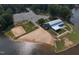 Aerial view of sandy beach, volleyball court and lake house on the water at 605 Shawnee Dr, Louisburg, NC 27549