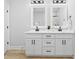 Bathroom with double vanity, modern hardware, and bright lighting at 605 Shawnee Dr, Louisburg, NC 27549