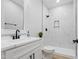 Modern bathroom featuring a tiled shower and sleek vanity at 605 Shawnee Dr, Louisburg, NC 27549