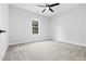 Bright bedroom with neutral carpet, ceiling fan, and large window at 605 Shawnee Dr, Louisburg, NC 27549