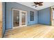 Covered deck boasts a ceiling fan, wood floors, and sliding doors at 605 Shawnee Dr, Louisburg, NC 27549