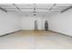 Spacious two car garage with concrete floor, water heater, and overhead door at 605 Shawnee Dr, Louisburg, NC 27549
