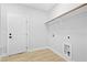 A well-lit laundry room with white walls and a wooden hanging bar and utility connections at 605 Shawnee Dr, Louisburg, NC 27549