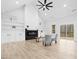 Living room with a fireplace, built-in shelving, and a fan at 605 Shawnee Dr, Louisburg, NC 27549