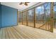 Screened porch with a ceiling fan and open views of the wooded backyard at 605 Shawnee Dr, Louisburg, NC 27549