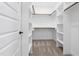 Spacious walk-in closet with built-in shelving and carpeted floors at 605 Shawnee Dr, Louisburg, NC 27549