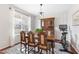 Elegant dining room with wood floors, statement lighting fixture, and large windows that provide natural light at 617 Hope Valley Rd, Knightdale, NC 27545