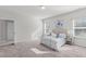 Spacious bedroom featuring two large windows, bedside tables, and a comfortable bed with decorative pillows at 6339 Grace Lily Dr, Raleigh, NC 27607