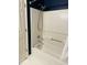 A standard white bathtub with a handheld shower head and white shower surround at 6520 Thetford Ct, Raleigh, NC 27615
