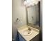 Bathroom with a neutral vanity and a bright, well-lit mirror and light fixture at 6520 Thetford Ct, Raleigh, NC 27615