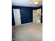 Bedroom with a dark blue accent wall and a neutral-colored carpet at 6520 Thetford Ct, Raleigh, NC 27615