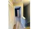Hallway leading to a bedroom with a neutral-colored carpet and blue walls at 6520 Thetford Ct, Raleigh, NC 27615