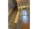 Bright hallway featuring wood floors, stairs, and plenty of natural light at 6520 Thetford Ct, Raleigh, NC 27615