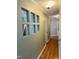 Hallway featuring wood floors and a decorative wall opening to the kitchen at 6520 Thetford Ct, Raleigh, NC 27615