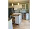 Updated kitchen featuring white cabinets, stainless steel appliances, and a kitchen island at 6520 Thetford Ct, Raleigh, NC 27615