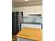 A kitchen boasts stainless steel appliances, white cabinets, and a grey countertop at 6520 Thetford Ct, Raleigh, NC 27615