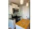 Bright kitchen featuring white cabinets, stainless steel appliances, and an adjacent kitchen island at 6520 Thetford Ct, Raleigh, NC 27615