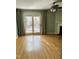 Bright living room featuring hardwood floors, fireplace, and sliding glass doors to backyard at 6520 Thetford Ct, Raleigh, NC 27615