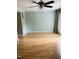 Well lit living room featuring hardwood floors, a ceiling fan, and sliding glass doors at 6520 Thetford Ct, Raleigh, NC 27615