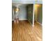 Open concept living room featuring hardwood floors and decorative wall opening to the kitchen at 6520 Thetford Ct, Raleigh, NC 27615
