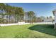 A spacious backyard with a well-manicured lawn and a shed behind a white fence at 654 Christian Light Rd, Fuquay Varina, NC 27526