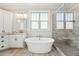 Bright bathroom features a soaking tub and glass-enclosed shower at 654 Christian Light Rd, Fuquay Varina, NC 27526