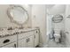 Bathroom featuring granite countertop, white cabinets, and decorative mirror at 654 Christian Light Rd, Fuquay Varina, NC 27526