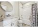 Bathroom featuring granite countertop, white cabinets, and shower/tub combo at 654 Christian Light Rd, Fuquay Varina, NC 27526