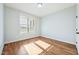Bright bedroom with hardwood floors and a large window at 654 Christian Light Rd, Fuquay Varina, NC 27526