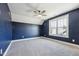 Bedroom with blue accent wall, carpet, and ceiling fan at 654 Christian Light Rd, Fuquay Varina, NC 27526