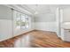 Bright dining room with paneled walls and large window overlooking the yard provides ample natural light at 654 Christian Light Rd, Fuquay Varina, NC 27526