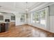 Bright dining room with paneled walls and large window overlooking the yard provides ample natural light at 654 Christian Light Rd, Fuquay Varina, NC 27526