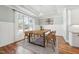 Bright dining room features a modern chandelier, paneled walls, and large windows that provide ample natural light at 654 Christian Light Rd, Fuquay Varina, NC 27526