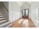 Bright foyer with hardwood floors, a staircase, paneled walls and double doors at 654 Christian Light Rd, Fuquay Varina, NC 27526