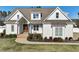 Charming white home with a well-manicured lawn and covered entryway showcasing its inviting curb appeal at 654 Christian Light Rd, Fuquay Varina, NC 27526