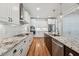 Gourmet kitchen features a large center island with granite countertops, stainless steel appliances, and pendant lighting at 654 Christian Light Rd, Fuquay Varina, NC 27526