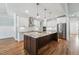 Gourmet kitchen features a large center island with granite countertops, stainless steel appliances, and pendant lighting at 654 Christian Light Rd, Fuquay Varina, NC 27526
