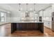 Gourmet kitchen features a large center island with granite countertops, stainless steel appliances, and pendant lighting at 654 Christian Light Rd, Fuquay Varina, NC 27526