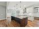 Gourmet kitchen features a large center island with granite countertops, stainless steel appliances, and pendant lighting at 654 Christian Light Rd, Fuquay Varina, NC 27526