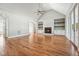 Bright living room with hardwood floors, fireplace, built-in shelves, and French doors leading to the outside at 654 Christian Light Rd, Fuquay Varina, NC 27526