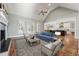 Cozy living room featuring ample seating, natural light, and an open layout connecting to the kitchen for easy entertaining at 654 Christian Light Rd, Fuquay Varina, NC 27526