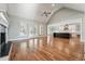 Expansive living room with vaulted ceilings, hardwood floors, and an open layout, perfect for gatherings and relaxation at 654 Christian Light Rd, Fuquay Varina, NC 27526